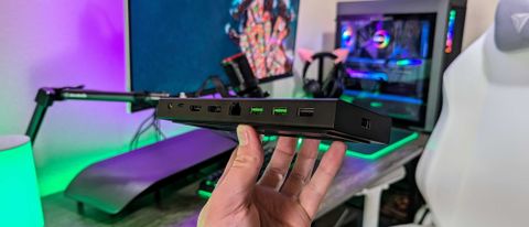 The Razer USB4 Dock held in the hand and showing its rear ports.