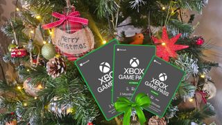 Xbox Game Pass Ultimate gift cards on a Christmas Tree background